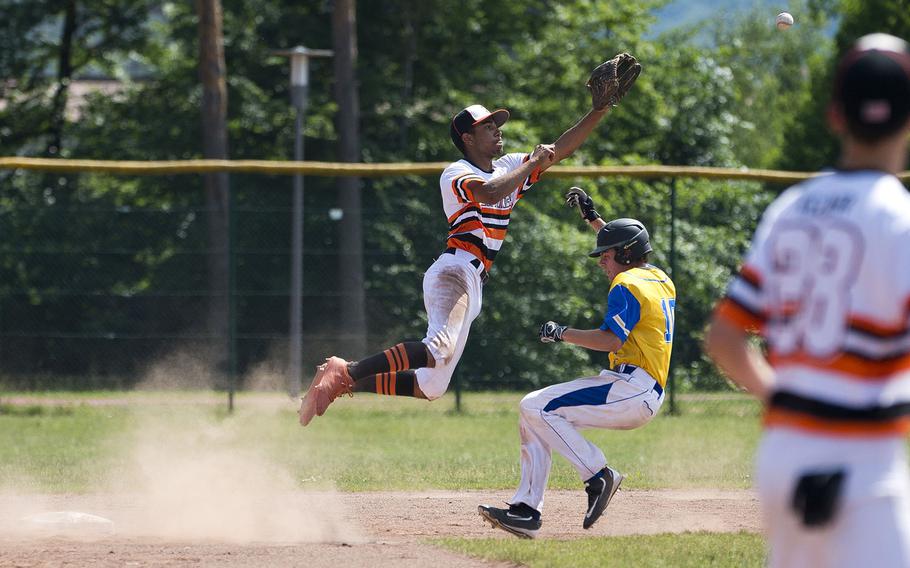 Spangdhalem's Tyriq Zvijer, left, leaps for a throw as Sigonella's Andrew Taylor runs to second during the DODEA-Europe Division II/III baseball championship at Ramstein Air Base, Germany, on Saturday, May 26, 2018.