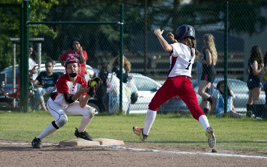 Kaiserslautern's Olivia Warren, left, catches Lakenheath's Catherine Oordt out at first during the DODEA-Europe Division I softball championship at Ramstein Air Base, Germany, on Saturday, May 26, 2018.
