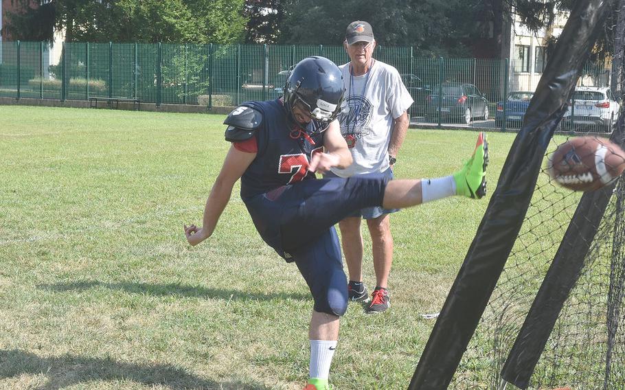 Aviano senior Giacomo Fabbro follows through on a kick in practice under the eyes of assistant coach Ken McNeely.