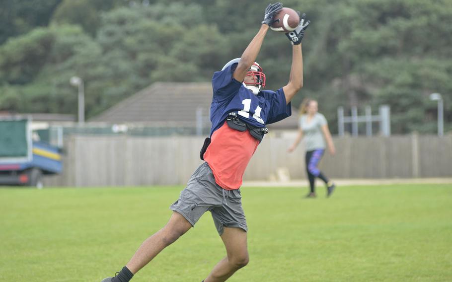 Lancer football receiver Cam Franklin catches the ball while running a two-minute offense drill in a preseason practice at RAF Lakenheath, England, Tuesday, Aug. 14, 2018.