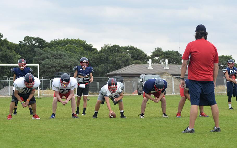 Coach Gabe Feletar runs his team through offensive plays during Lancer football preseason practice at RAF Lakenheath, England, Tuesday, Aug. 14, 2018.