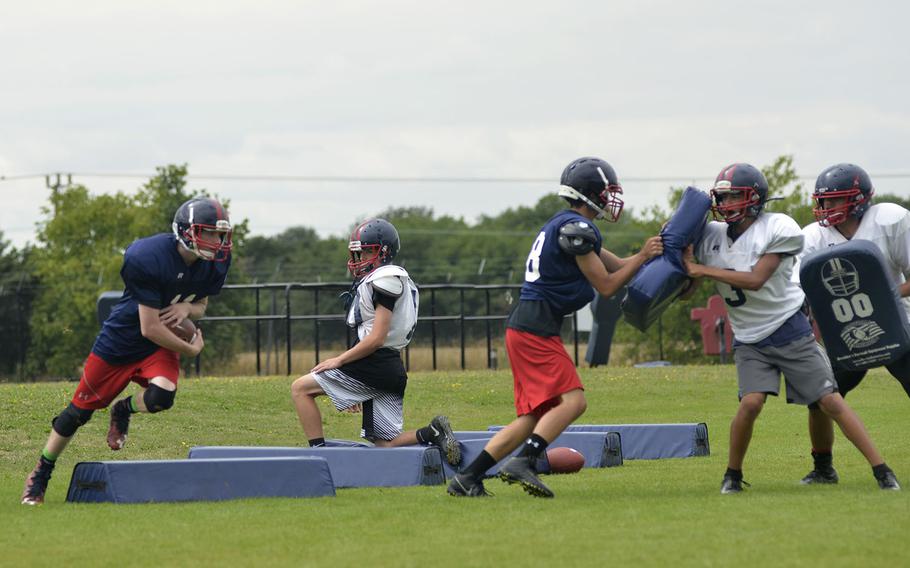 Lancer football players run drills during an afternoon preseason practice at RAF Lakenheath, England, Tuesday, Aug. 14, 2018. The Lancers have three new assistant coaches and a potential roster with 35 rookie and returning players this season.