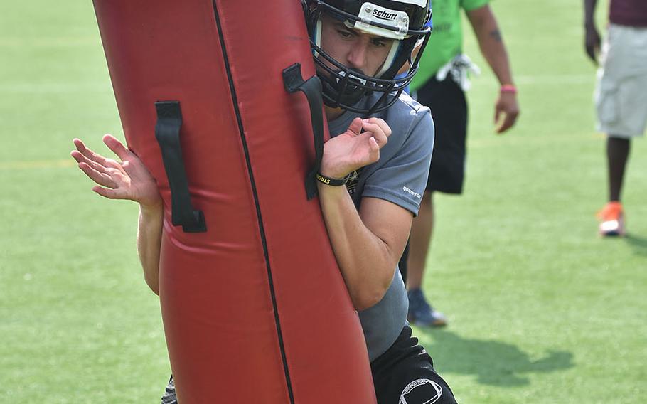 Vicenza senior Cole Keck goes through a tackling drill during a recent practice at Caserma Ederle in Italy.