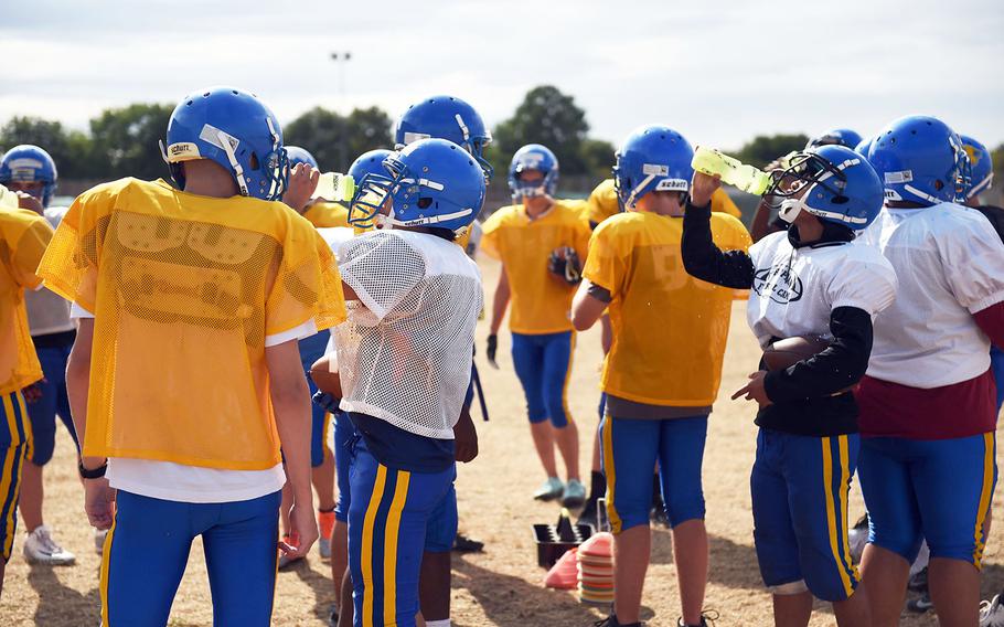 The Ansbach Cougars hydrate during practice, Monday, August 27, 2018. 