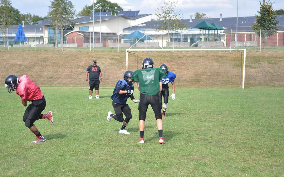 Spangdahlem Sentinels players run a drill under the supervision of new head coach Chris Howard at a preseason practice session at Spangdahlem High School. Howard plans to deploy the Sentinels' historically successful run-based offense with a few "wrinkles."