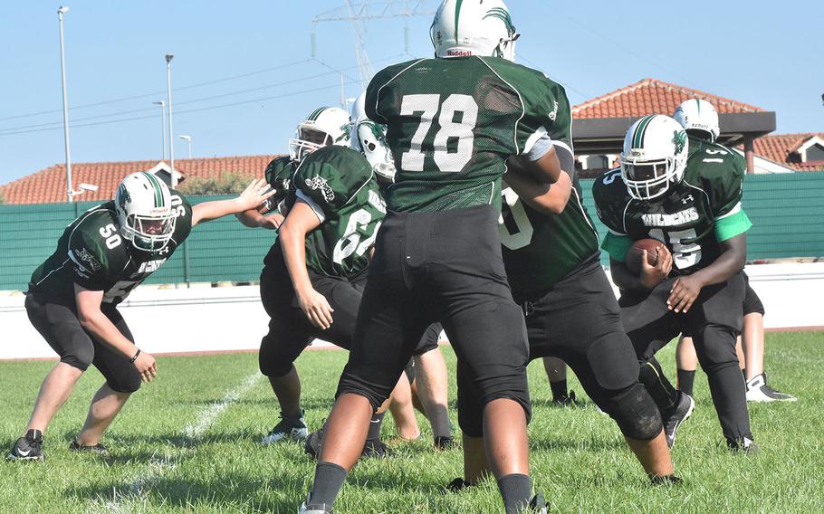 The Naples Wildcats do drills to practice defending against a running offense. Their first opponent, SHAPE, is expected to have little in way of a passing game. 