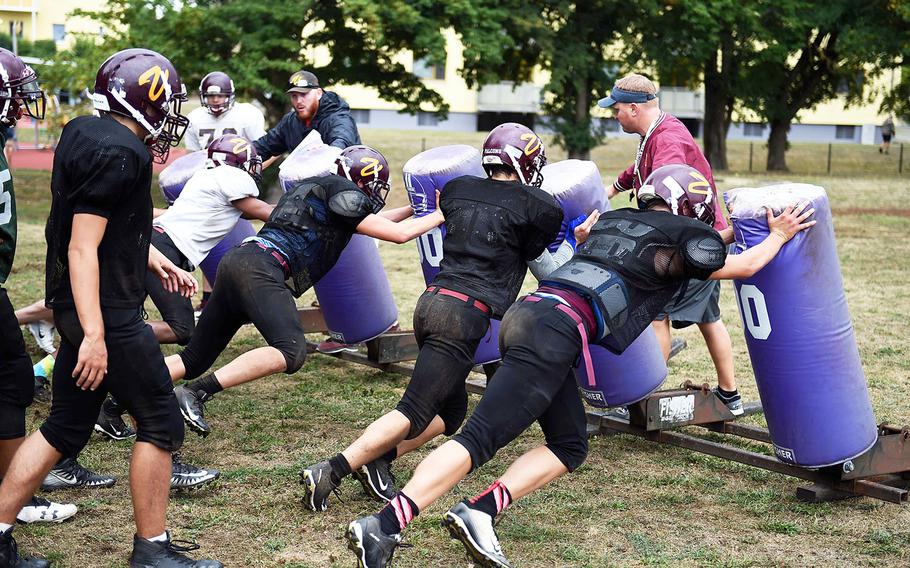 The Vilseck Falcons hit the sleds during practice, Friday, Aug. 31, 2018, at Vilseck, Germany. 