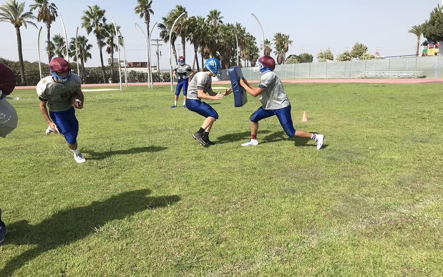 Rota Admirals players collide in a preseason football practice at Rota, Spain. The Admirals have played in every Division II championship game since 2015, including a win in 2016.