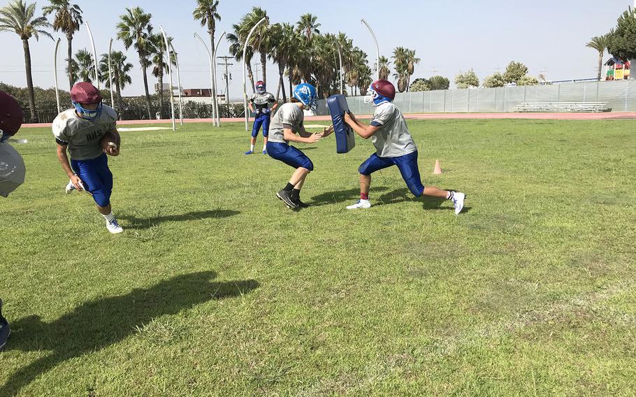 Rota Admirals players collide in a preseason football practice at Rota, Spain. The Admirals have played in every Division II championship game since 2015, including a win in 2016. 