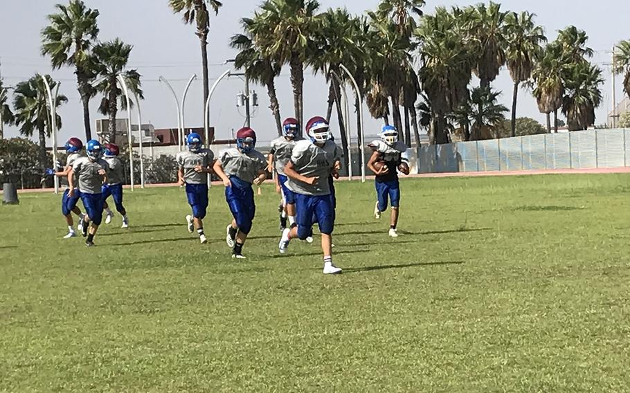 Rota Admirals football players run across the field in a practice session at Rota, Spain. The Admirals will play the first four games of their regular season on the road. 