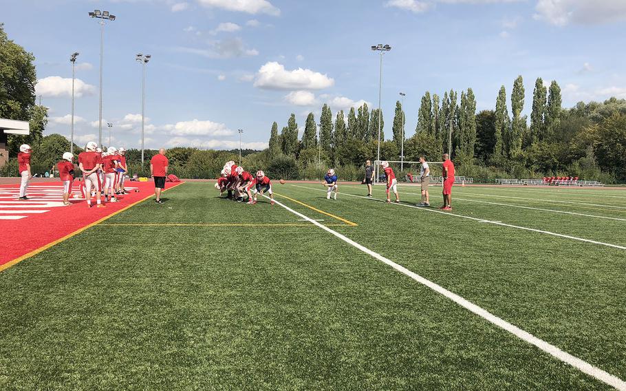 International School of Brussels conducts a drill at a preseason practice session. The Raiders open their regular season Saturday at Aviano. 