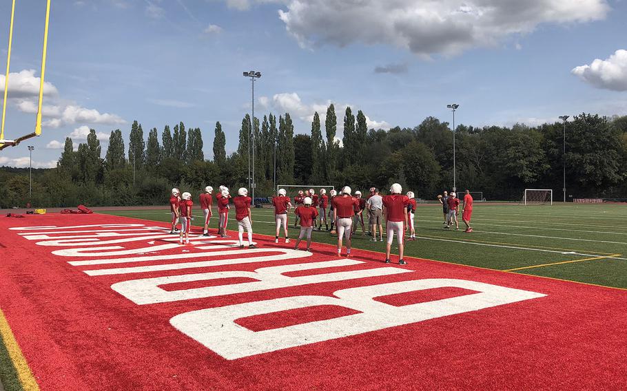 The International School of Brussels Raiders gather for a preseason practice session. The Raiders missed the playoffs last season despite a .500 overall and regional record. 