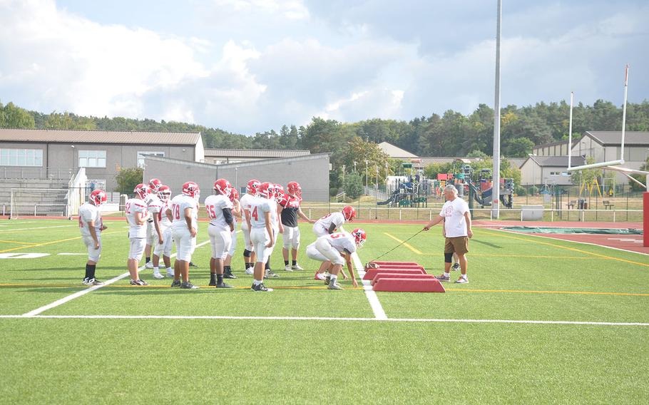 New coach Robert Allen shows his Raiders football squad what he's looking for during a drill in a recent preseason practice at Kaiserslautern, Germany.