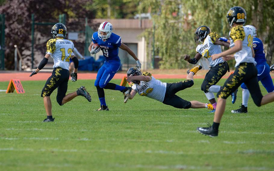 Jason Jones Jr. breaks a tackle as he runs for the first down during the Ramstein vs Stuttgart football game Saturday, Sept. 15, 2018.  Ramstein won the game 41-19.