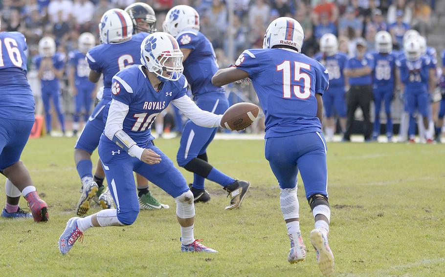 Ramstein quarterback Jakob Steinbeck hands off to running back JJ Little in the Royals' 41-19 defeat of Stuttgart on Saturday, Sept. 15, at Ramstein Air Base. Steinbeck has stepped in as Ramstein's starting quarterback after an extended stint with the school's JV squad. 