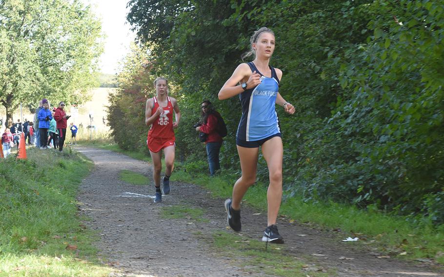 Black Forest Academy senior Bianca Liberti led Kaiserslautern sophomore Chloe Martin after two laps on Saturday, Sept. 29, 2018, at the Ramstein cross country meet in Miesenbach, Germany. Martin went on to win in a time of 19:25.61.