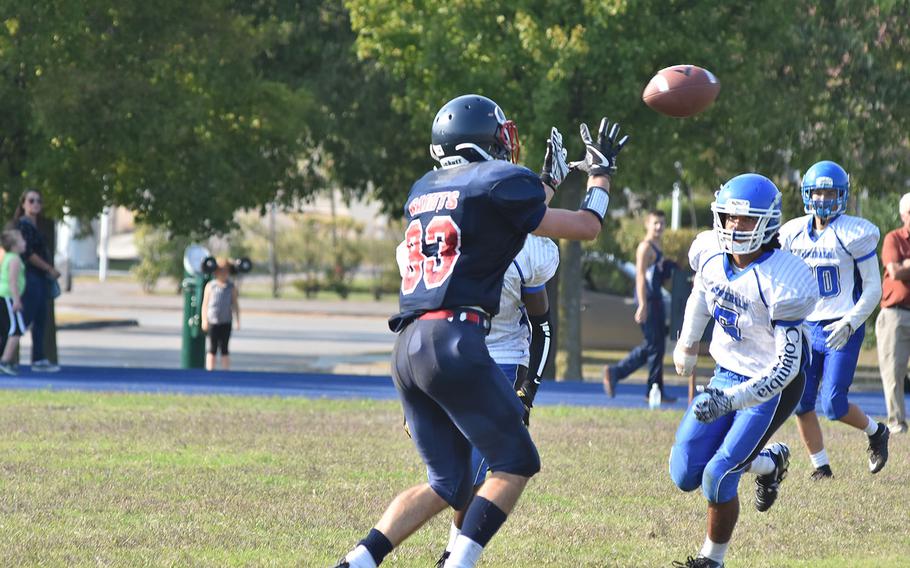 Aviano's Michael Hauser watches the ball spiral toward him for a catch as Rota's Ray Reyes closes in.