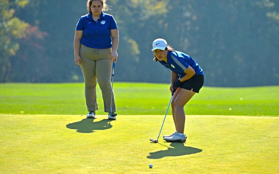Ramstein's Phoebe Shin watches her ball head toward the cup on the ninth hole during first-day action at the DODEA-Europe golf championships at Rheinblick golf course in Wiesbaden, Germany, Wednesday, Oct. 10, 2018. Watching is teammate Lauren Sutherland.





