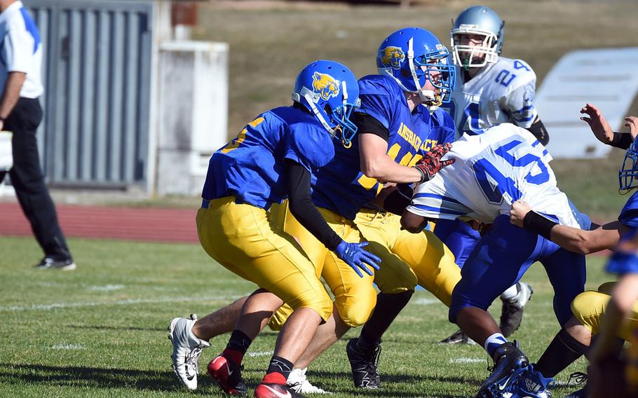 A group of Ansbach Cougars stop Brussels' Kimouri Vaughan, right, during a game at Ansbach, Germany, Saturday, Oct. 13, 2018. 