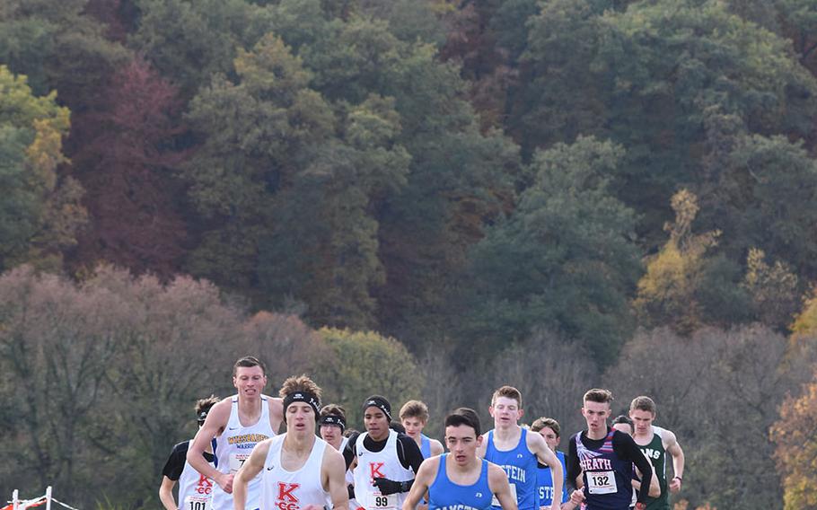 Ramstein's Dashiell Rogers, right, began to make his move on Kaiserslautern's Joseph Purvis and the rest of lead pack early on in the 2018 DODEA-Europe boys cross country championships on Saturday, Oct. 27, 2018, at Baumholder, Germany. Rogers won his first European title and set a new course record.