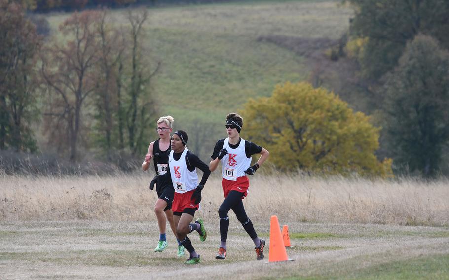 Stuttgart's Brice Brown, from left, and Kaiserslautern's Orlando Rojas and Griffen Parsells, run in a pack at the 2018 DODEA-Europe boys cross country championships on Saturday, Oct. 27, 2018, at Baumholder, Germany.

