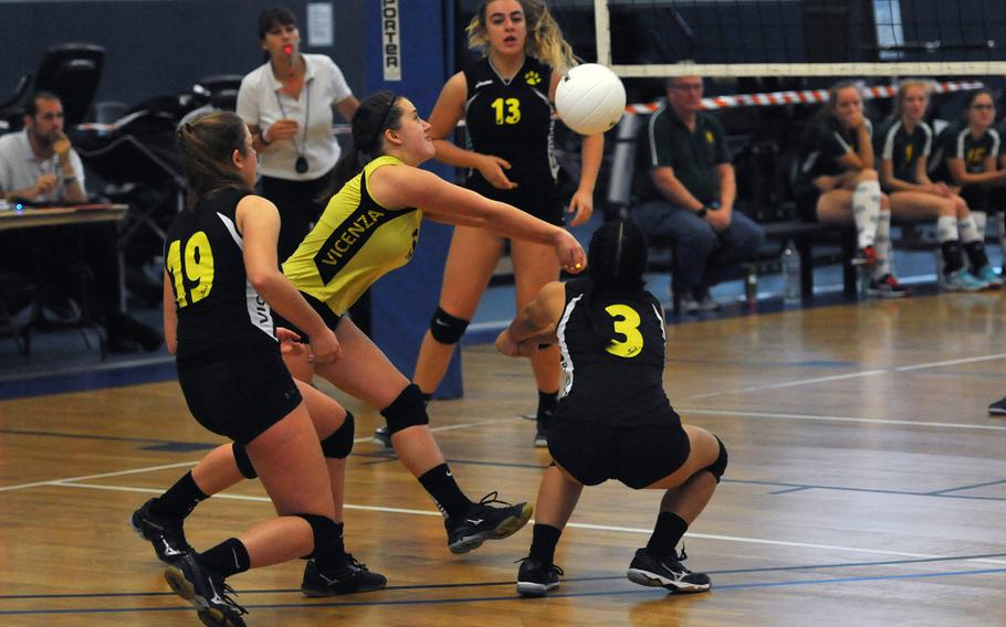 Surrounded by teammates, Vicenza libero Emilee Deck returns the ball in the Cougars' 25-12,25-22,25-13 win over SHAPE on the first day of action at the DODEA-Europe volleyball finals in Kaiserslautern, Germany, Thursday, Nov. 1, 2018. 





