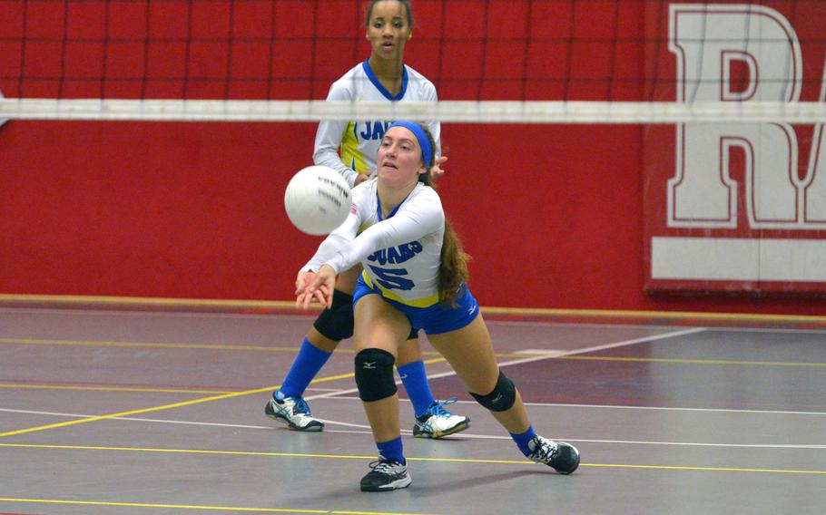Sigonella's Jessie Jacobs digs out a Spangdahlem serve as teammate Averi Chandler watches. Sigonella defeated Spangdahlem 25-17, 25-20, 21-25, 25-20  in a Division III semifinal at the DODEA-Europe volleyball finals in Kaiserslautern, Germany, Friday, Nov. 2, 2018.