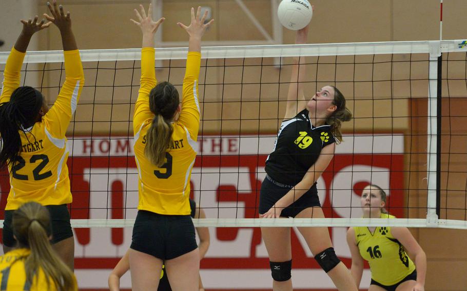 Vicenza's Madeline Mollner hit the ball against the Stuttgart block of Skye DeSilva Mathis, left, and Audrey Moeding. The Panthers beat the Cougars 34-31, 25-14, 25-14 to advance to Saturday's Division I final against Ramstein.