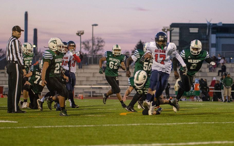 Josiah Cooper from Aviano breaks the last tackle to score during the DODEA-Europe Dvision II football championship game between the Aviano Saints and the Naples Wildcats, Saturday, Nov. 3, 2018. 