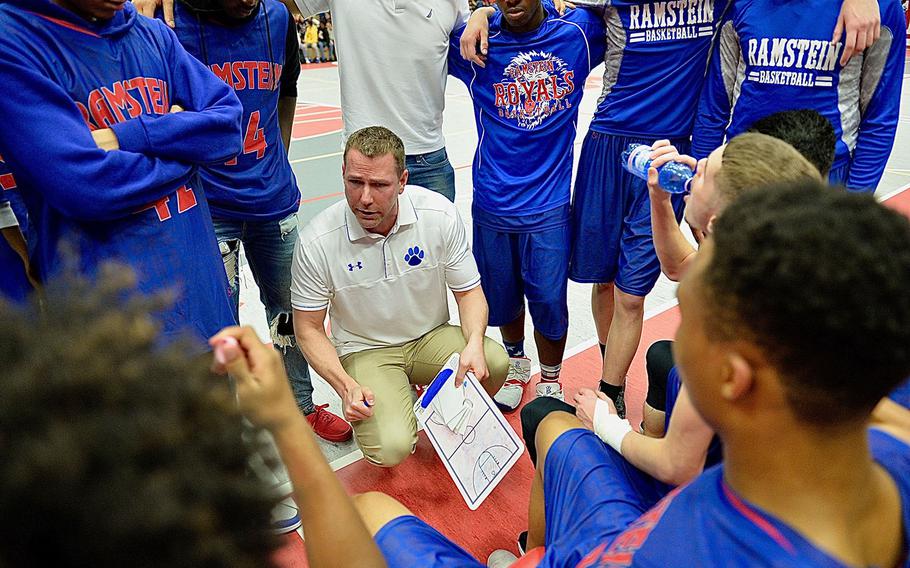 Ramstein coach Andrew O'Connor directs Royals players during a timeout. The Royals went on the beat the Raiders 60-41. 