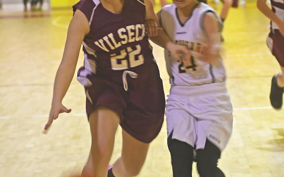 Vilseck's Hannah Marr heads toward the basket while Vicenza's Anersy Rivera defends on Friday in the Falcons' 44-21 win.