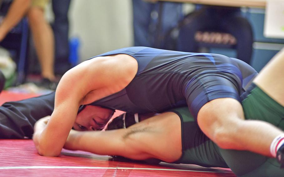 Roberts Swart, a junior from Ankara Elementary High School, Ankara Air Base, Turkey wrestles against Griffin Fletcher from Naples during Saturday's wrestling tournament held at Aviano Air Base.