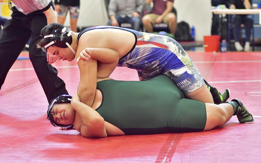 Augusto De Sousa Matos from Naples attempts to pin Xzavyer Salas, also from Naples, during Saturday's wrestling tournament held at Aviano Air Base. De Sousa Matos and Salas compete in the 220-pound bracket. De Sousa won all his matches during the tournament. 