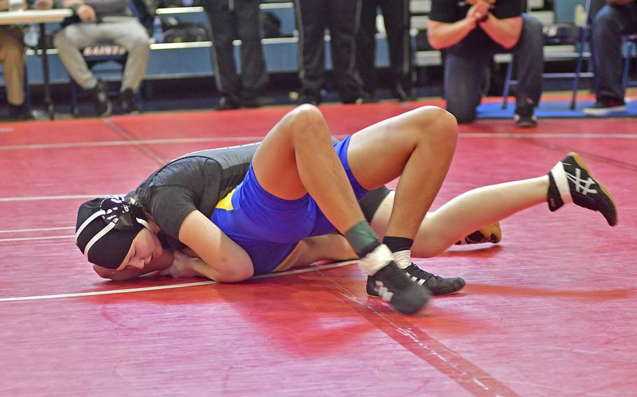 Olivia Crutchley from Vicenza works on pinning Arland Matthias from Sigonella during Saturday's wrestling tournament held at Aviano Air Base. Crutchley is one of three girls on the Vicenza wrestling team. She wrestled in the 145-pound bracket at this tournament. 