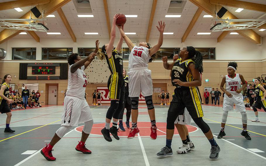 Players fight for control during a varsity basketball game between Stuttgart and Kaiserslautern at Kaiserslautern High School, Germany, Friday, Feb. 8, 2019. Stuttgart won the game in overtime 45-44.