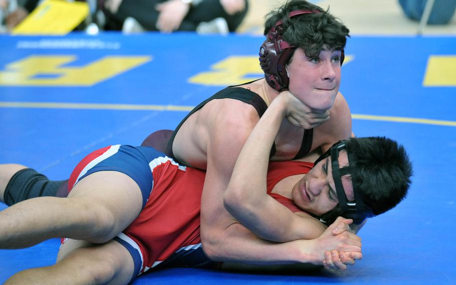 Vilseck's Hyrum Draper puts the pressure on Aviano's Daniel Merrill in a 160-pound match at the DODEA-Europe wrestling championships in Wiesbaden, Germany, Friday, Feb. 15, 2019. 





