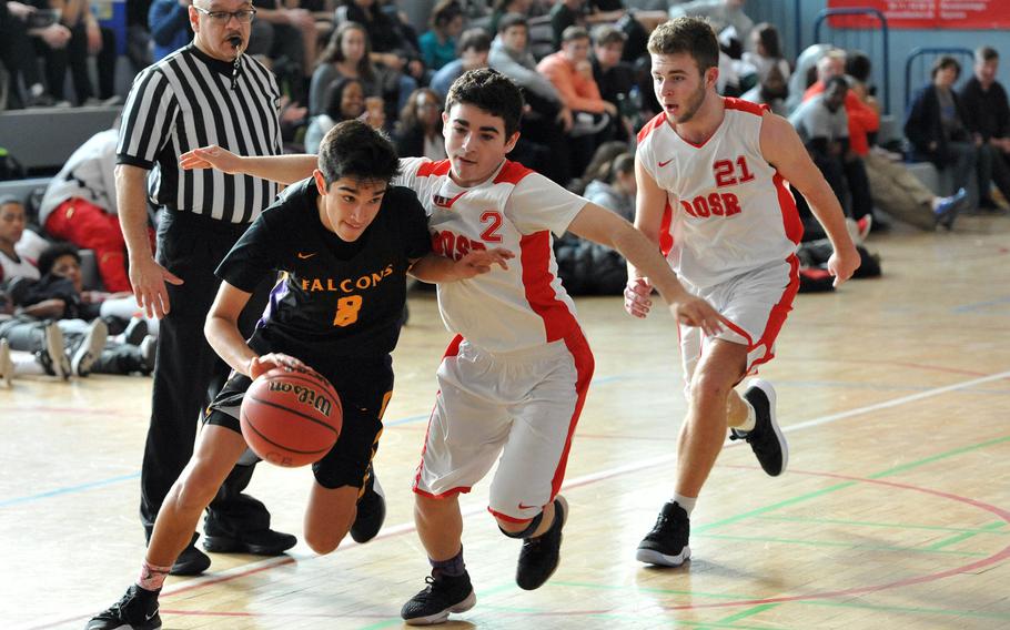 Bahrain's Cooper Lawrence gets past AOSR's Ran Eshel and Niv Eshel in a Division II game at the DODEA-Europe basketball finals. Bahrain won 46-27.