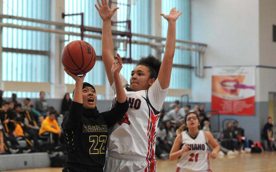 Bahrain's Tasneem Abdkhair shoots against Aviano's Keyona Williams in a Division II game at the DODEA-Europe basketball finals. Bahrain won 37-34.






