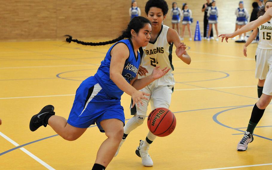 Hohenfels' Yosleen Alokoa drives to the basket against Alconbury's Alynna Markarian in a Division III game at the DODEA-Europe basketball finals. Alconbury beat Hohenfels 45-29.






