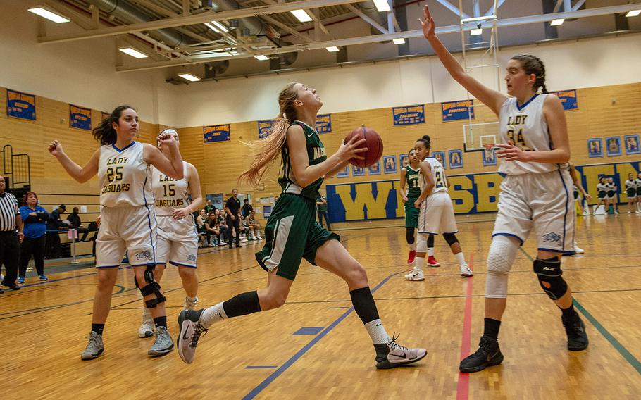 Alconbury's Marissa Kastler drives to the basket during a Division III semifinall game between Sigonella and Alconbury at Wiesbaden High School, Germany, Friday, Feb. 22, 2019. Sigonella won the game 36-31.