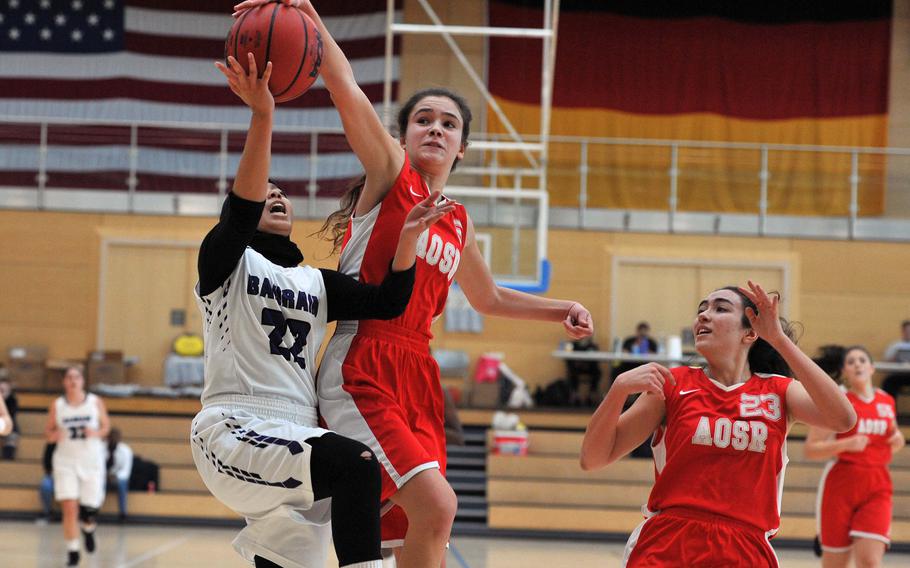 AOSR's Amaya Vaquerizo can only stop a fast break by Bahrain's Tasneem Abdkhair with a foul in a girls Division II semifinal at the DODEA-Europe basketball championships in Wiesbaden, Germany. AOSR won the game 35-27 to advance to Saturday's final against AFNORTH.