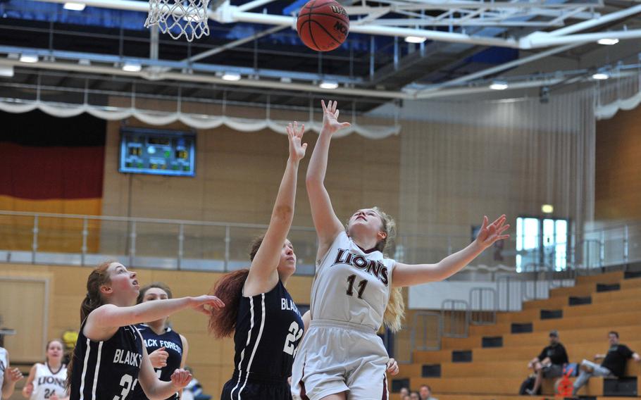 AFNORTH's Victoria Morris shoots as Black Forest Academy's Leila Zharmenova defends in a girls Division II semifinal at the DODEA-Europe basketball championships in Wiesbaden, Germany. AFNORTH won 34-32 to advance to Saturday's final.