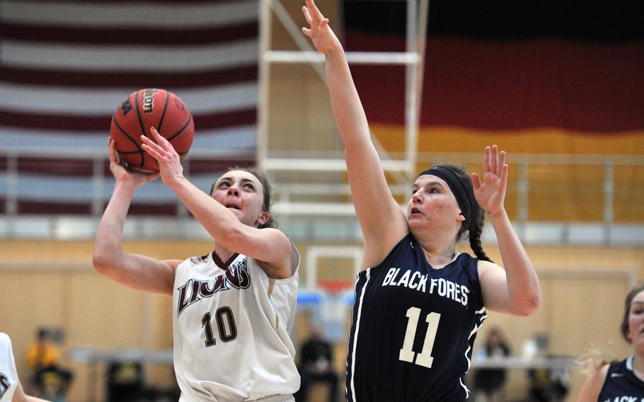 AFNORTH's Ashley Bailey looks for a shot as Black Forest Academy's Jessie Campbell defends. AFNORTH beat BFA 34-32 to advance to Saturday's Division II title game at the DODEA-Europe basketball championships in Wiesbaden, Germany. 