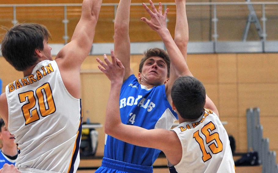 Marymount's Gregorio Ricci shoots over Bahrain's Peter Curling, left, and Theodore Curling in a Division II semifinal at the DODEA-Europe basketball championships in Wiesbaden, Germany. Bahrain won the game 63-40.









