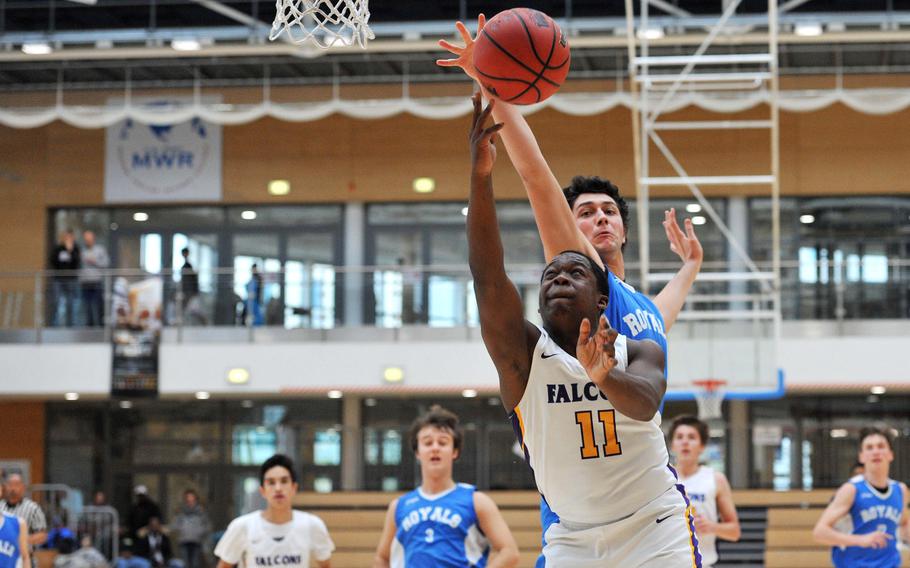 Bahrain's Derrick Lee gets past Marymount's Gianmaria Bellucci for a basket in the Falcons' 63-40 win in a Division II semifinal at the DODEA-Europe basketball championships in Wiesbaden, Germany. 