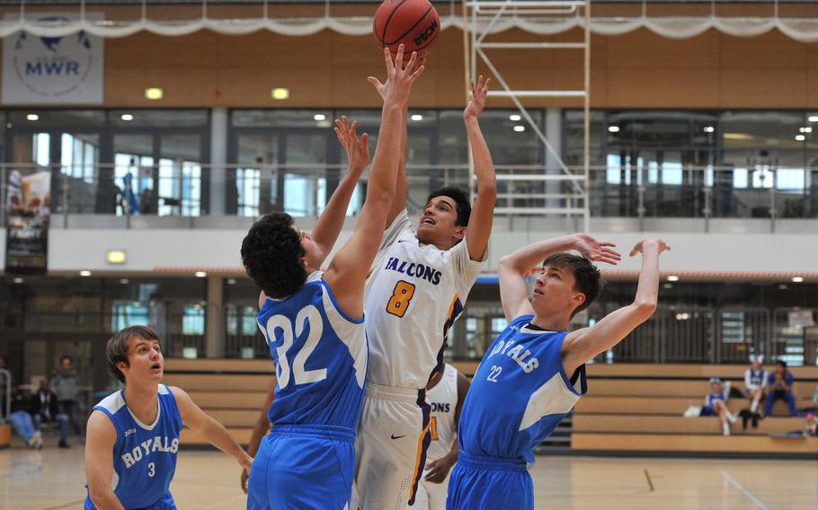 Bahrain's Cooper Lawrence goes up for a shot between Marymount's Gianmaria Bellucci, left, and Francesco Gnecco in a Division II semifinal at the DODEA-Europe basketball championships in Wiesbaden, Germany. Bahrain won 63-40 to advance to the divisional final.