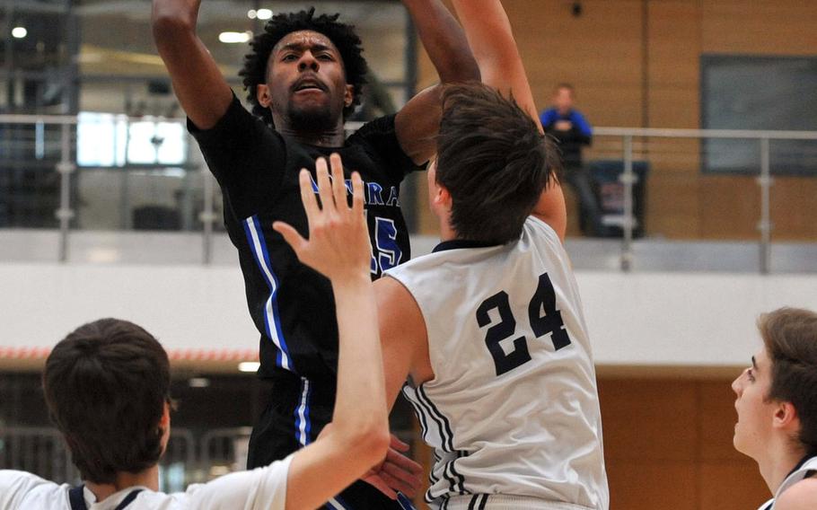 Rota's Antonio White scores over Black Forest Academy's Gabriel Kruse in a Division II semifinal at the DODEA-Europe basketball championships in Wiesbaden, Germany. BFA won 49-47 to advance to Saturday's final against Bahrain.