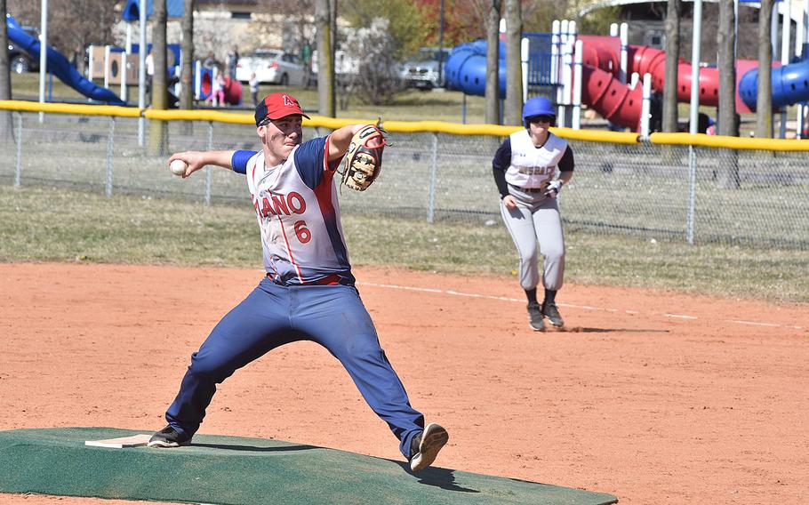 Aviano pitcher Nick Smith readies a pitch while Ansbach's Jacquie Muszczynski leads off first base.