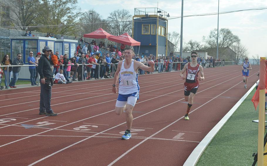 Roberto Eiseman, a Wiesbaden senior, crosses the finish line in first place after the boys 3,200-meter run, in Wiesbaden, Saturday, March 30, 2919. The race was part of a 13-school track and field meet.Eiseman spent most of the race trailing the leader, but used his speed to take first in the last 200 meters of the race.