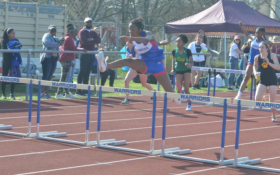 Jaya Worthington, a Ramstein senior, takes a hurdle as she holds onto the lead during the 300-meter race at Wiesbaden High School, Saturday, March 30, 2019. 

